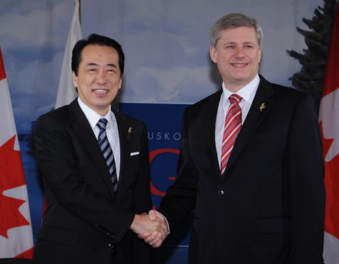 カナダのハーパー首相と握手する菅総理の写真