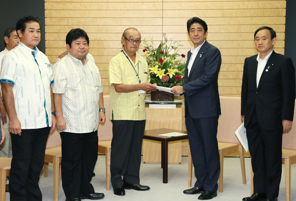 安倍总理在总理大臣官邸接受了来自冲绳县促进军用地转用与基地问题协议会的要求。